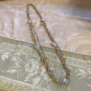 Gold and silver necklace with star design. Smithsonian logo I believe